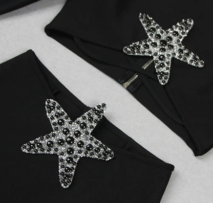 Conjunto dos piezas negro manga larga con detalle de estrella en falda y top